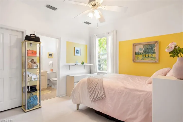 Bedroom featuring connected bathroom, a ceiling fan, and light colored carpet