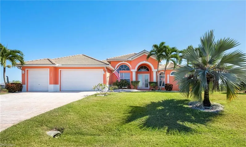Mediterranean / spanish-style house featuring french doors, a garage, driveway, and a tile roof
