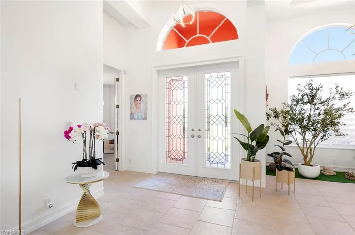 Entrance foyer featuring a high ceiling and french doors