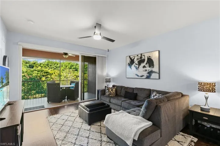 Living room with a ceiling fan and wood finished floors