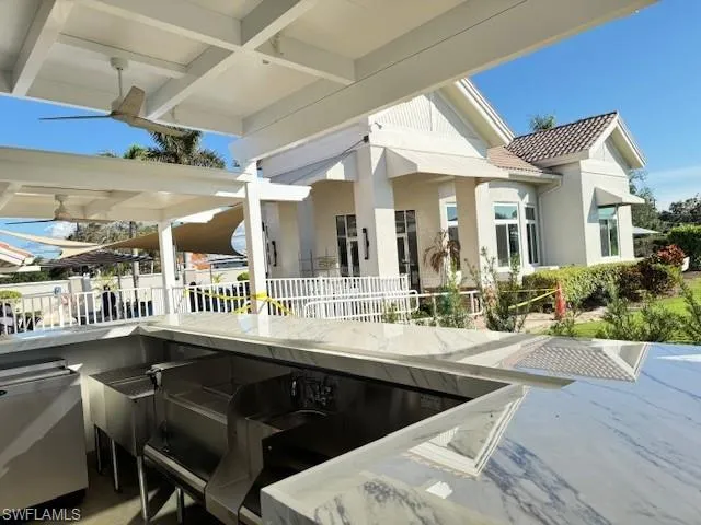 View of patio / terrace featuring fence and outdoor dry bar