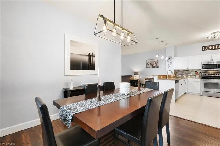Dining area featuring an inviting chandelier, baseboards, and wood finished floors