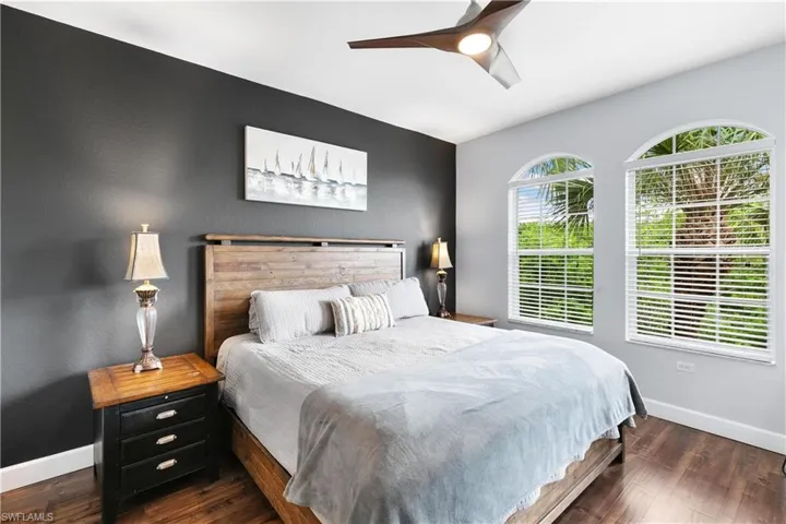Bedroom with baseboards, ceiling fan, and wood finished floors