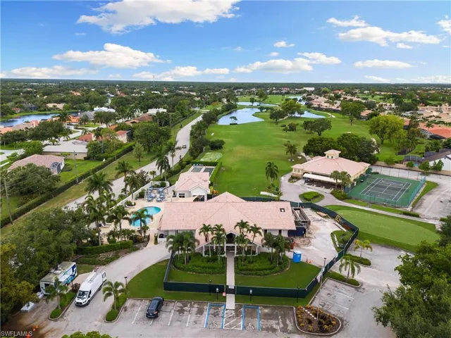Birds eye view of property with view of golf course and a water view