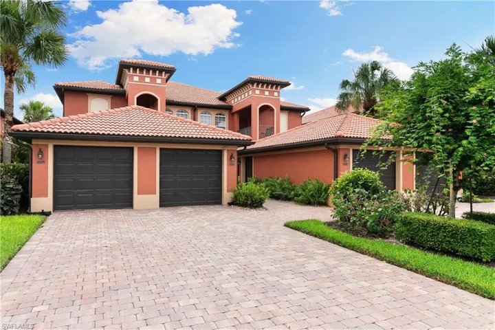 Mediterranean / spanish-style house with a tiled roof, decorative driveway, a garage, and stucco siding