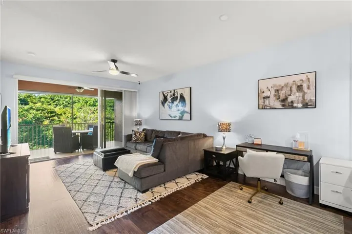 Living room featuring ceiling fan and wood finished floors