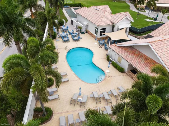 Community pool with fence and a patio