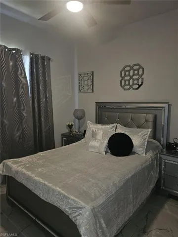 Bedroom featuring marble finish flooring