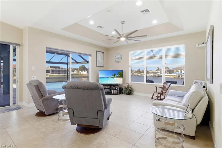 Relax or entertain in this light-filled living room with walls of glass framing the tranquil waterfront scenery.
