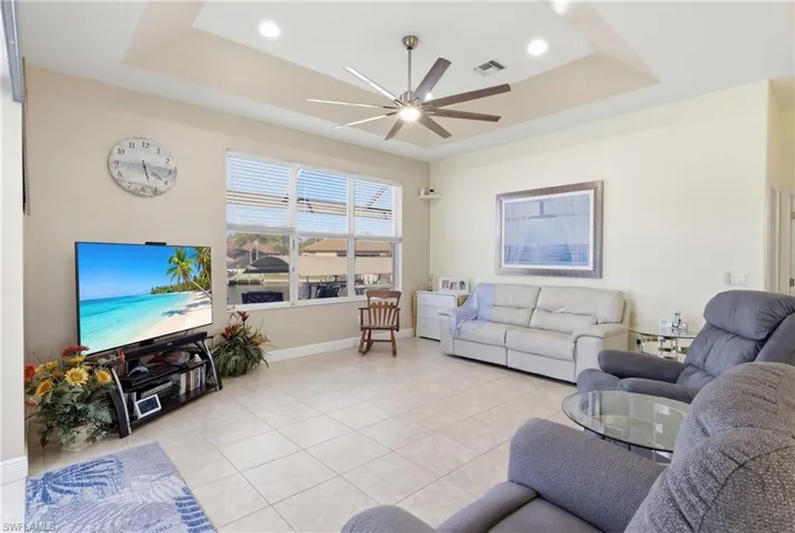 Spacious family gathering area enhanced by tray ceilings and stunning canal views.