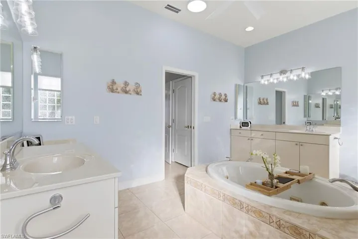 Spa-inspired primary bath featuring dual vanities, soaking tub, and an expansive shower.