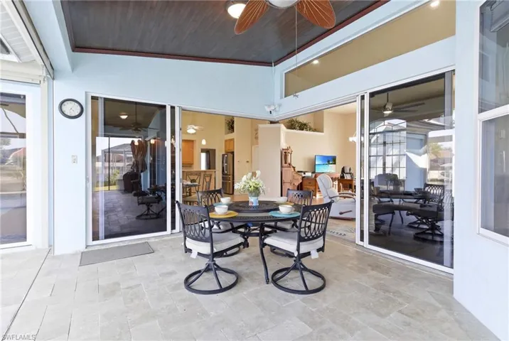 Seamless indoor-outdoor living as the dramatic 90-degree slider opens completely to the waterfront lanai.