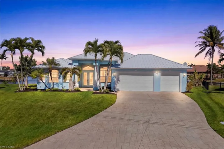 A stunning waterfront residence perfectly positioned on an intersecting canal, offering exceptional curb appeal and coastal elegance.