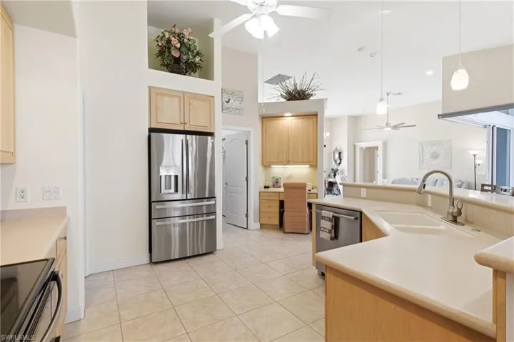 Beautifully designed kitchen with ample counter space, storage, and a built-in desk offering convenience and style.