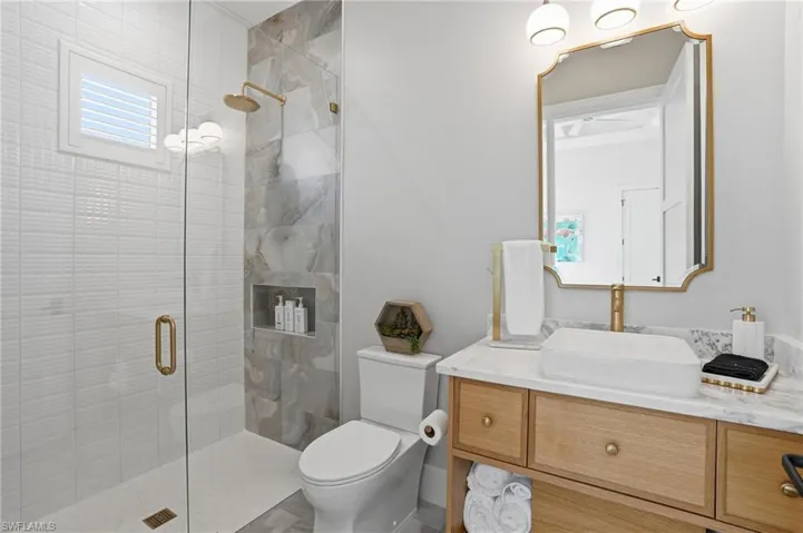 Full bathroom featuring vanity and a stall shower - Virtually Edited Image
