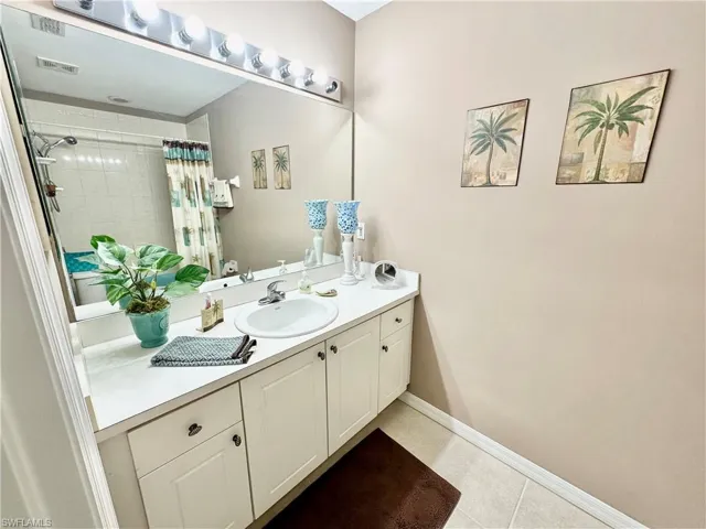 Bathroom featuring tile patterned floors and vanity