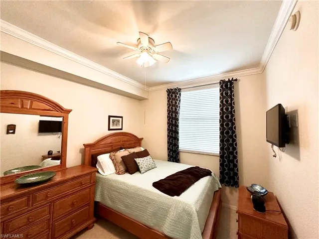 Bedroom with ceiling fan and crown molding