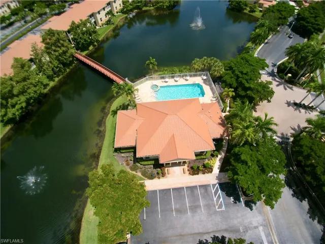 Birds eye view of property with a water view