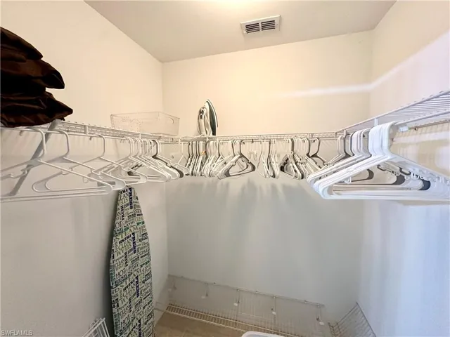 Walk in closet with tile patterned flooring