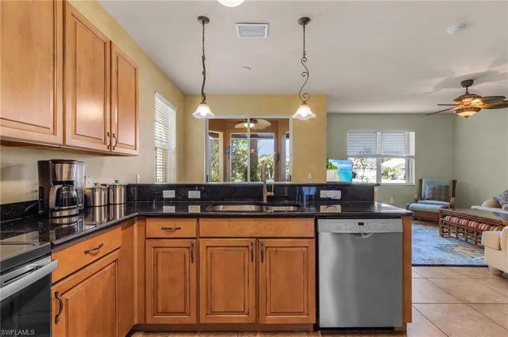 Kitchen featuring appliances with stainless steel finishes, ceiling fan, open floor plan, and healthy amount of natural light