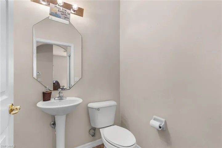 Bathroom with toilet and baseboards