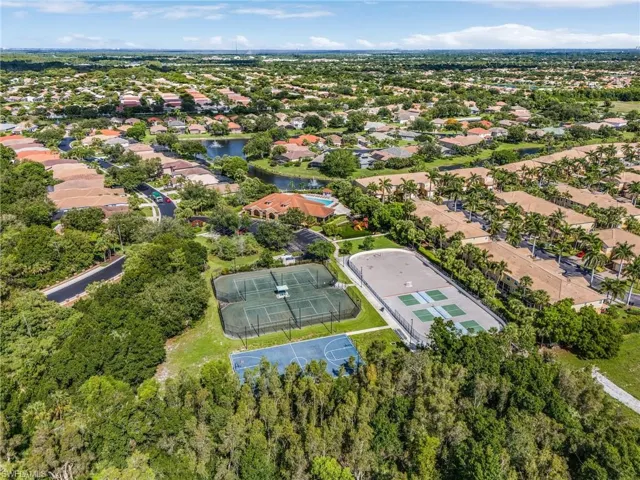 Aerial view of residential area featuring a nearby body of water