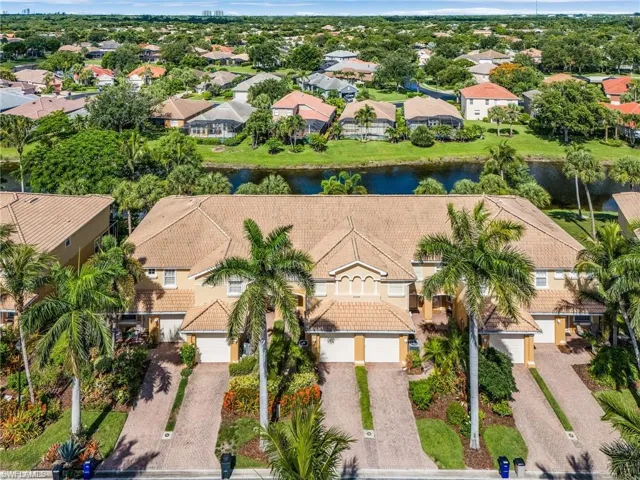 Aerial perspective of suburban area featuring a large body of water