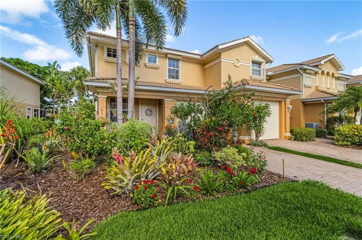 Mediterranean / spanish home with decorative driveway, stucco siding, and a tile roof