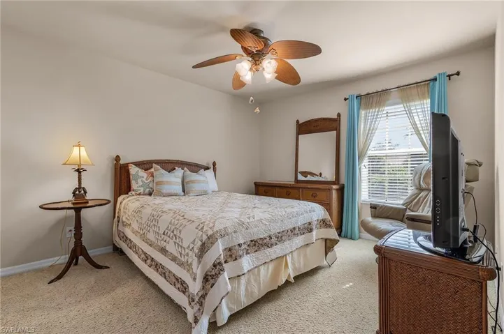 Bedroom featuring light colored carpet and ceiling fan