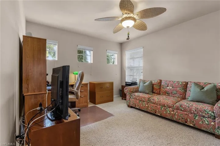 Office featuring a ceiling fan and carpet flooring