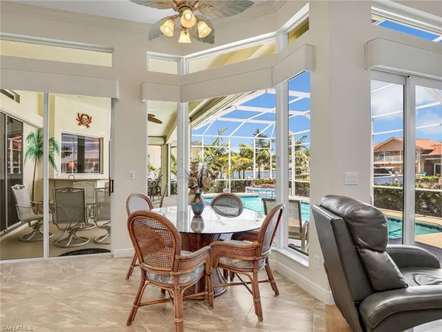 Sunroom with a patio, outdoor dining area, and ceiling fan