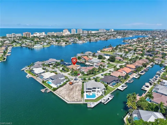 Aerial overview of property's location with nearby suburban area and a large body of water