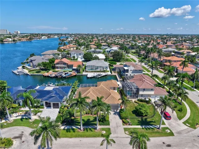 Aerial perspective of suburban area featuring a large body of water