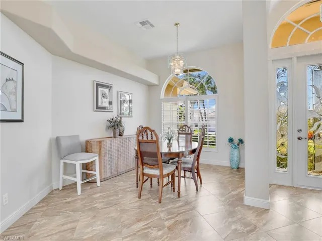 Dining area featuring a chandelier and baseboards