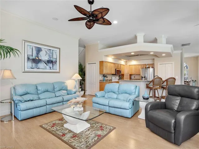 Living area with crown molding, recessed lighting, light wood-style flooring, and ceiling fan