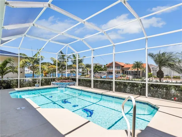 Outdoor pool featuring a lanai and a sunroom