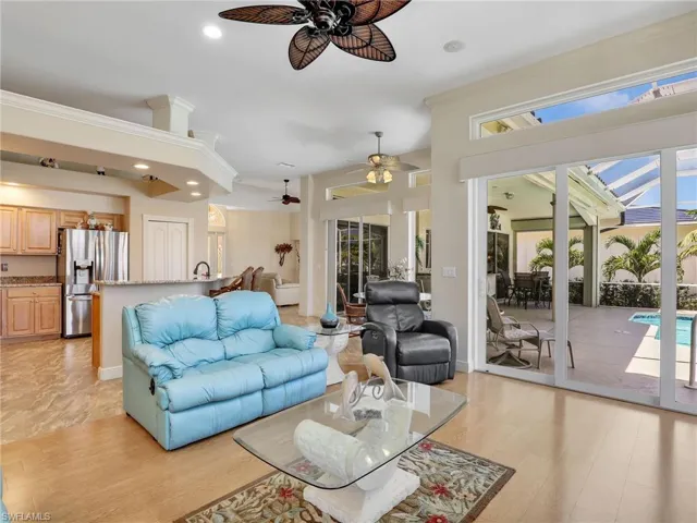Living area featuring recessed lighting, a sunroom, crown molding, and light wood-type flooring