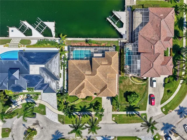 Bird's eye view of a pool and a nearby body of water