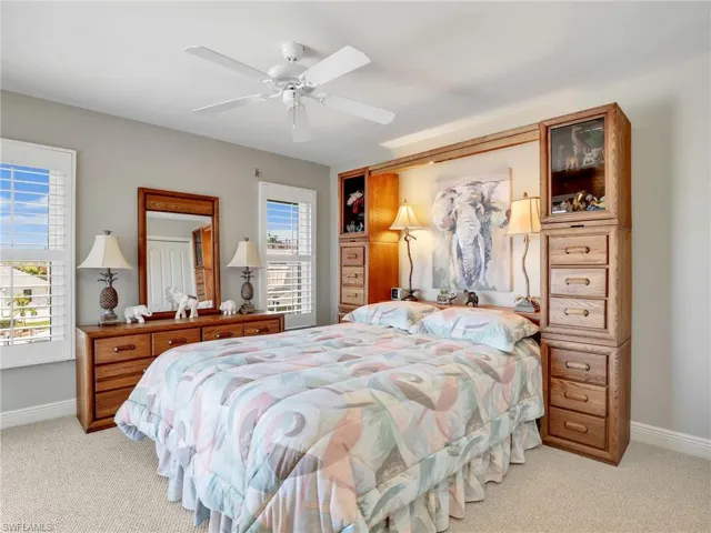 Bedroom featuring light carpet and ceiling fan
