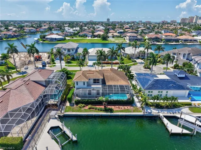 Aerial perspective of suburban area with a nearby body of water