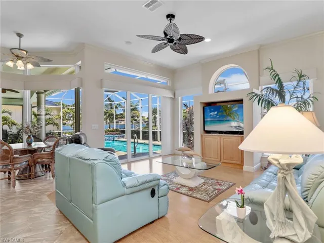 Living room featuring crown molding, a sunroom, and light wood-style floors