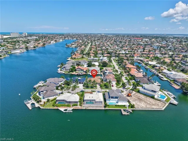 Aerial perspective of suburban area featuring a nearby body of water