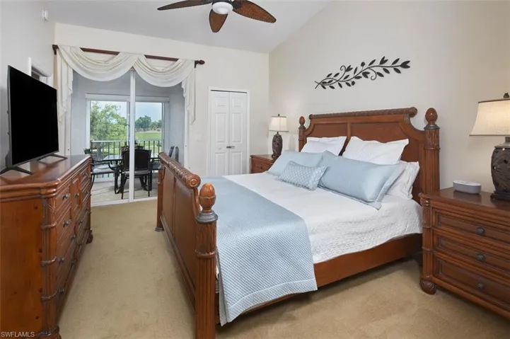 Carpeted bedroom with ceiling fan, access to exterior, and a closet