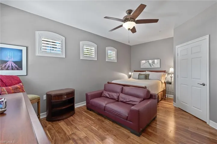 Bedroom with ceiling fan and wood-type flooring