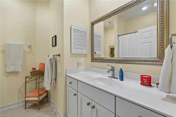 Bathroom featuring tile patterned flooring and vanity