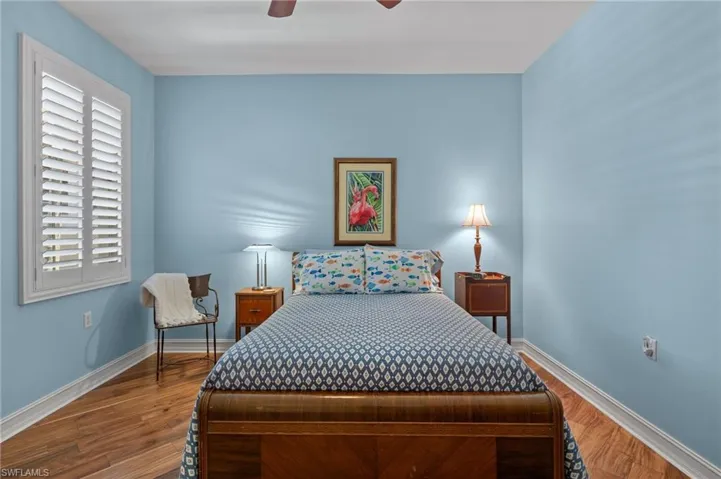 Bedroom featuring ceiling fan and wood-type flooring
