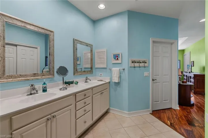 Bathroom featuring hardwood / wood-style flooring and dual vanity