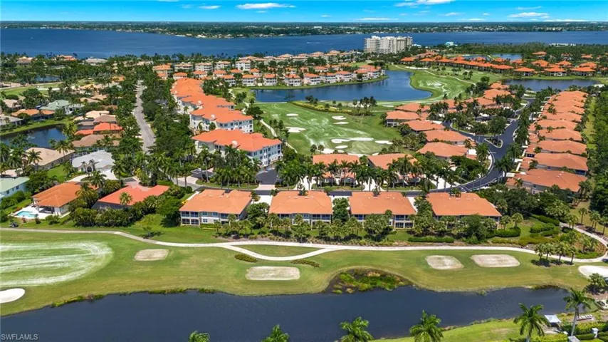 Birds eye view of property with a water view