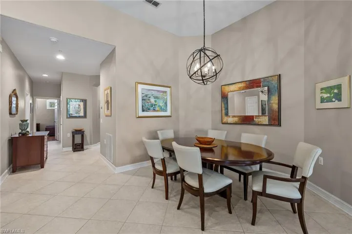 Dining space with a notable chandelier and light tile patterned flooring