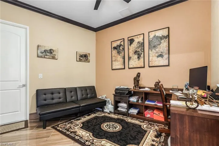 Office featuring crown molding, light wood-type flooring, and ceiling fan
